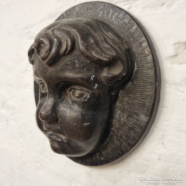 Hammered from antique iron (?), embossed relief plaque depicting a child's head - ep