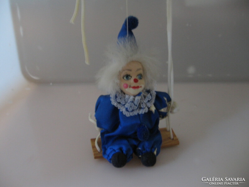 Seated clown with a retro porcelain head