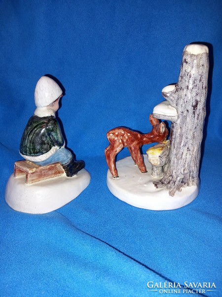 2 Izsépy ceramic figurines of a boy sledding and a deer at the feeder