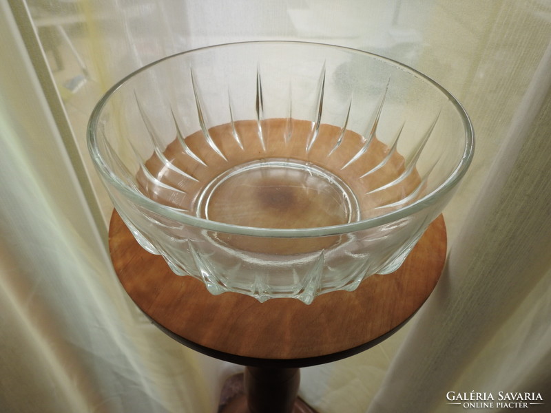 A huge glass bowl with small bowls
