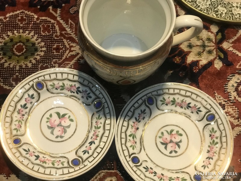 A large cup and two matching smaller plates