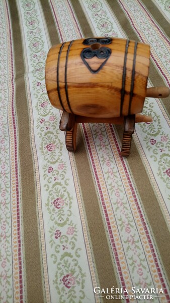 An old carved wooden miniature keg placed on a stand is a display case!