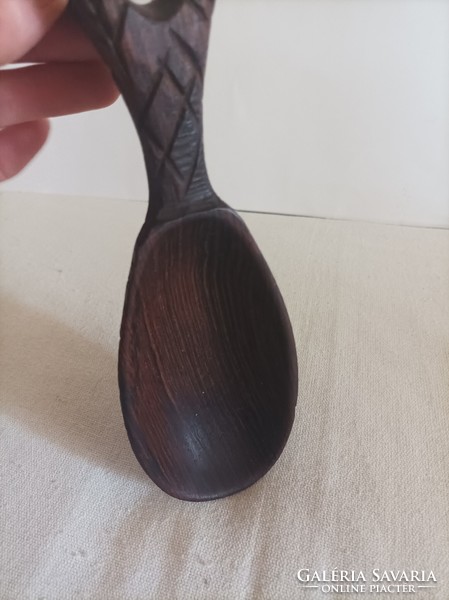 Carved wooden spoon in the shape of a pineapple, dark brown