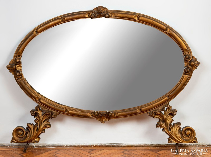 Oval console mirror in a gilded wooden frame