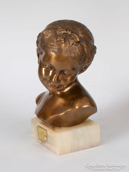 Smiling little girl bust on marble plinth