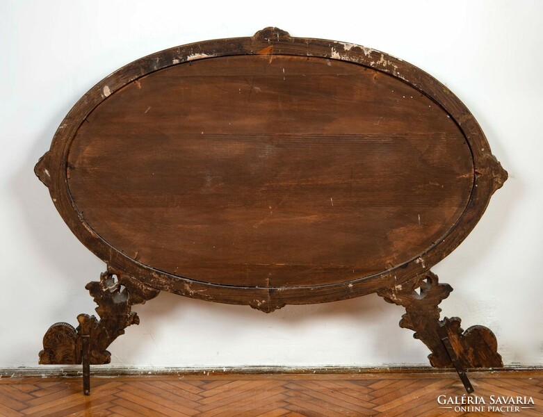 Oval console mirror in a gilded wooden frame