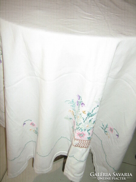 Beautiful antique tablecloth with a flower basket embroidered with many small cross stitches