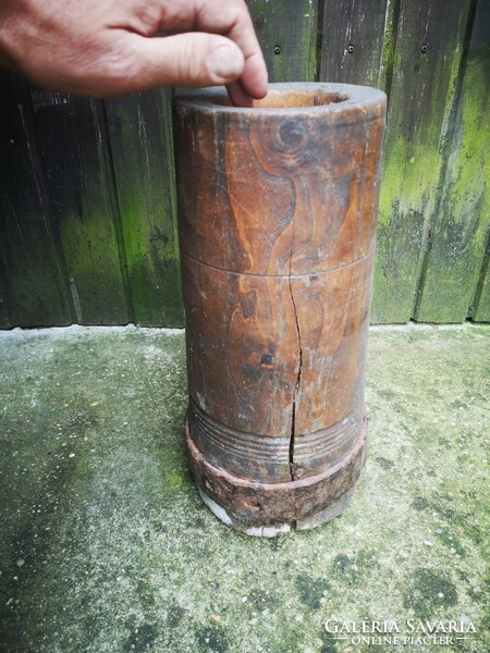 Antique wooden mortar with wrought iron hammer 1800s folk museum-type object. Crop seeds