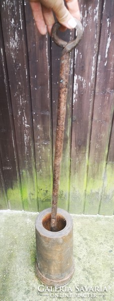 Antique wooden mortar with wrought iron hammer 1800s folk museum-type object. Crop seeds