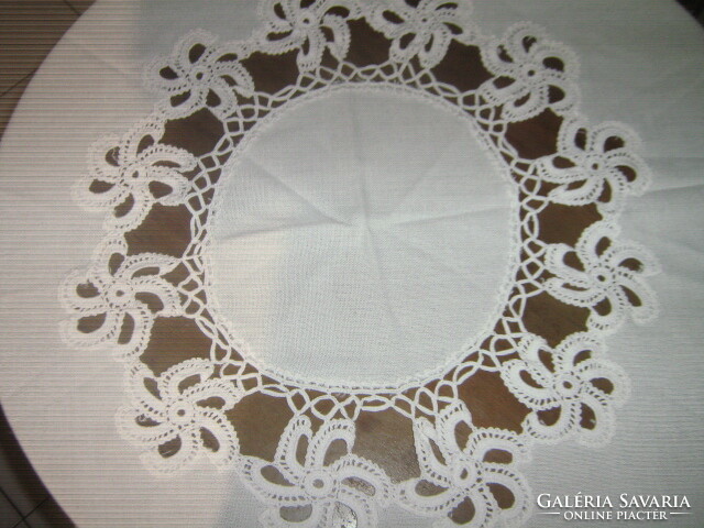 A huge round festive tablecloth in a cream color with a fabulous hand-crocheted flower insert