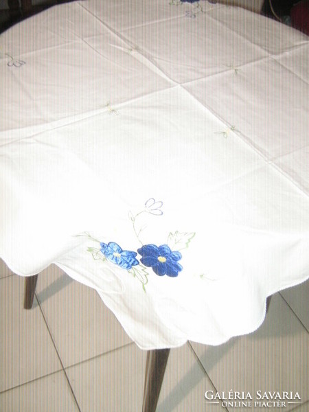 A beautiful tablecloth with a blue floral appliqué pattern