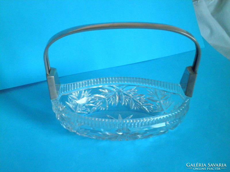 Thick glass oval centerpiece with metal handle, offering