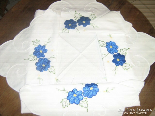 A beautiful tablecloth with a blue floral appliqué pattern