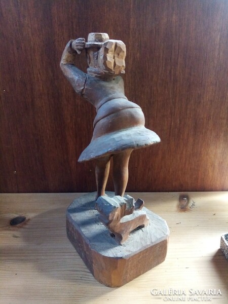 Wooden sculpture, against the wind (in the style of Marilyn Monroe), with a dog