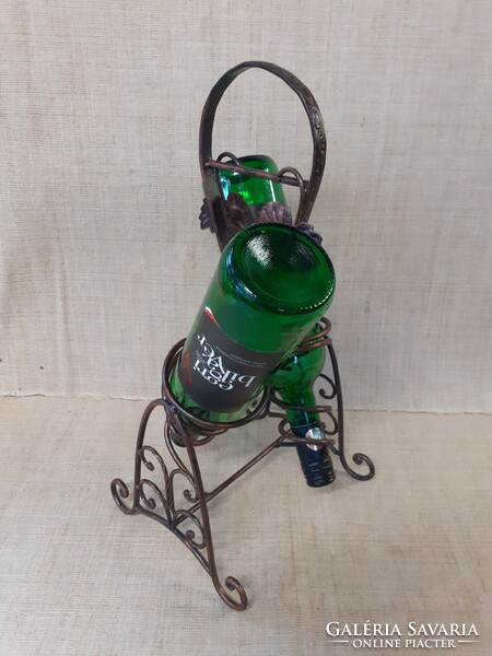 Metal tabletop wine bottle holder with grape leaf pattern in good condition