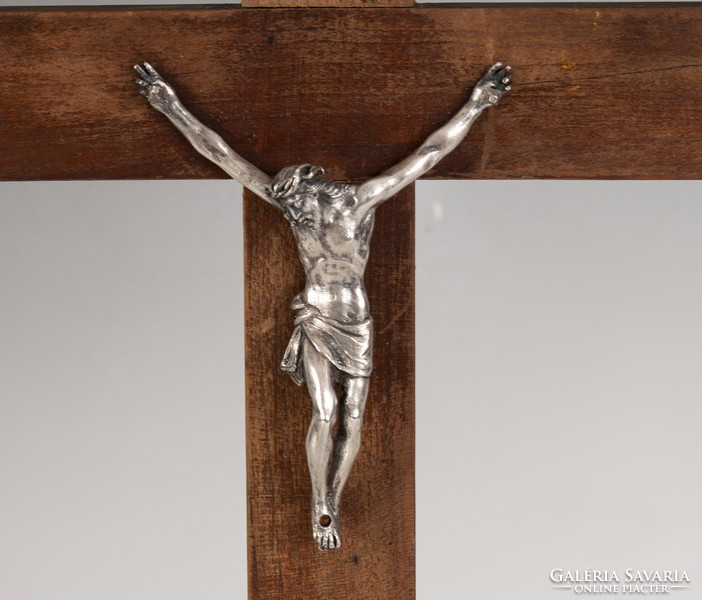 Silver crucifix on wooden cross