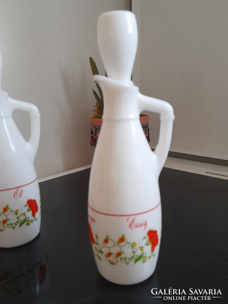 A pair of milk bottles holding oil and vinegar