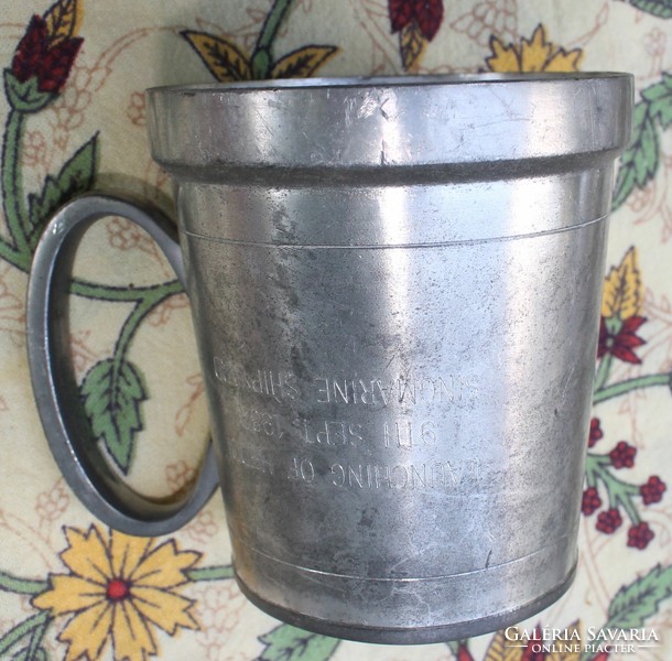 A cup with a pewter handle