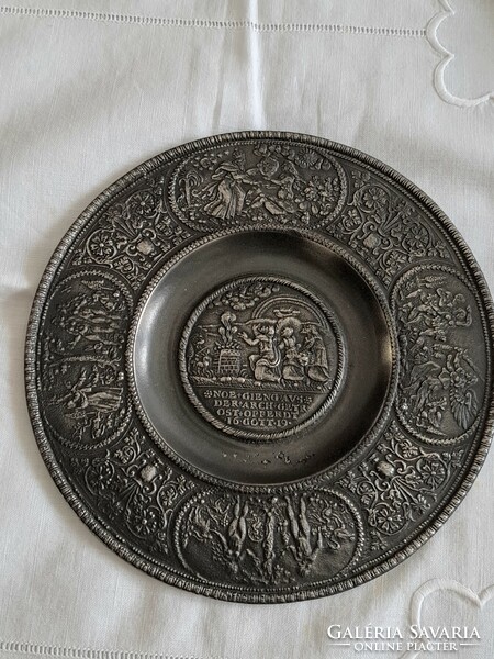 Embossed pewter plate with a religious scene