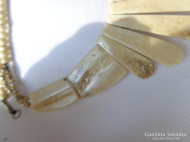 Old bone necklace with signs and pattern