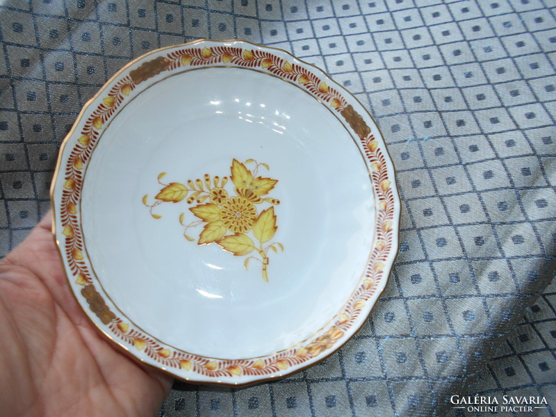 A plate with an Appony pattern - served from its rare orange size on the bottom of a tea cup