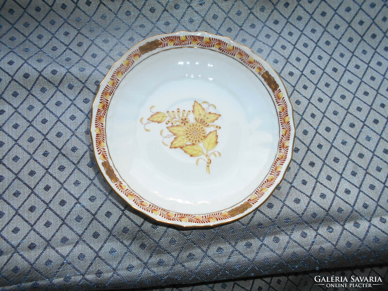 A plate with an Appony pattern - served from its rare orange size on the bottom of a tea cup