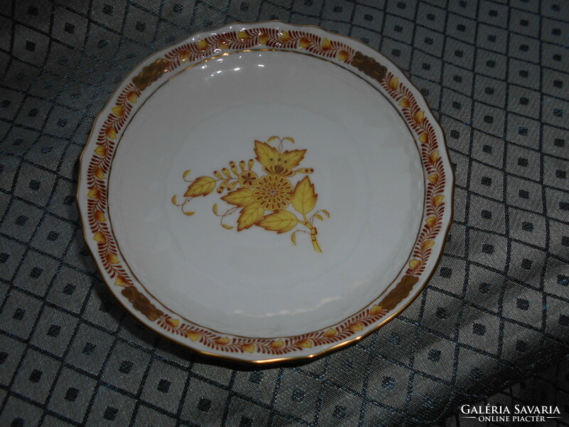 A plate with an Appony pattern - served from its rare orange size on the bottom of a tea cup