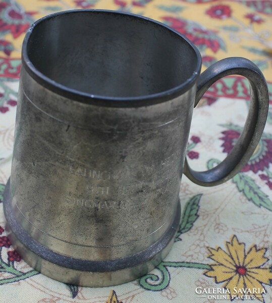 A cup with a pewter handle