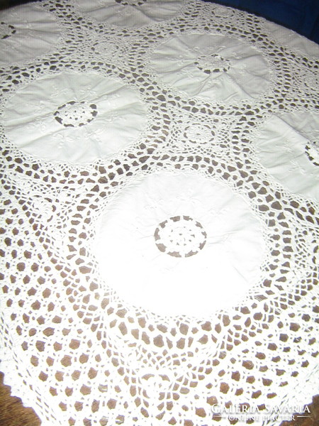 A beautiful tablecloth with hand-crocheted edges and crocheted inserts with Art Nouveau features