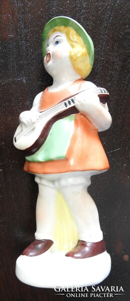 Child playing guitar - porcelain figure