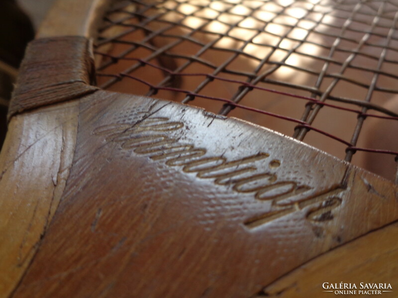 Antique tennis racket, with contemporary canvas case, marked old sports equipment from the 1910s