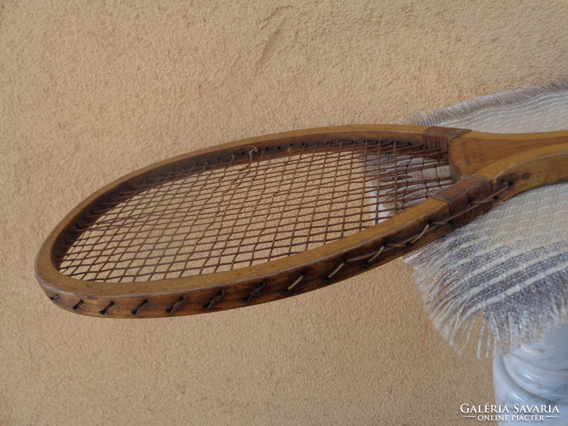 Antique tennis racket, with contemporary canvas case, marked old sports equipment from the 1910s
