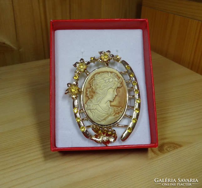 Handmade cameo brooch. Precisely worked golden color with a silky shine. Gold number. Beautiful case.