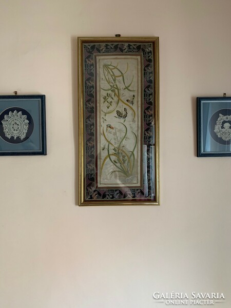 Embroidered caterpillar silk wall decoration in a frame