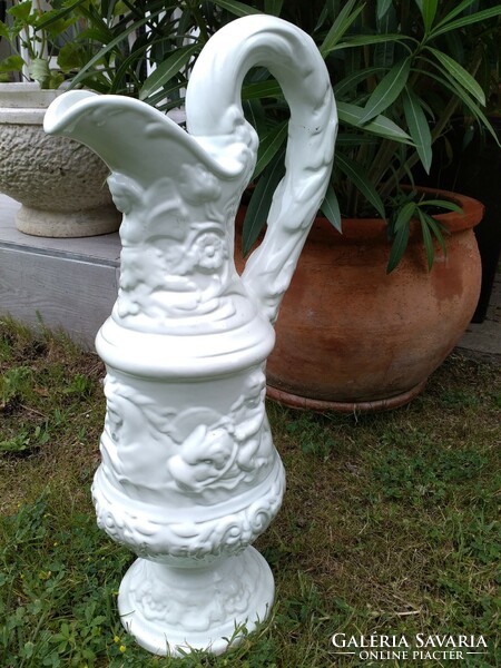 White capodimonte ceramic carafe decorated with giant puttos