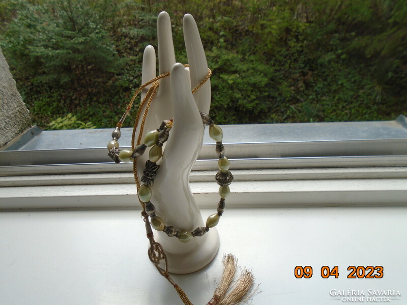 Interesting neck blue Celtic knot with gold thread cord, pale green opal glass and figurative silver beads