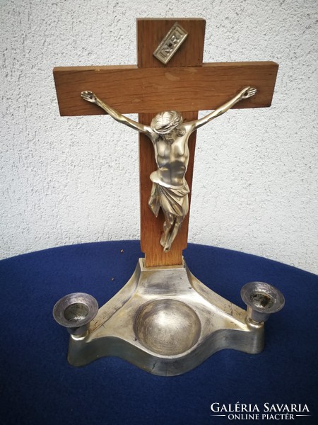 Candlestick with crucifix and holy water holder made of metal. Home altar, blessed Jesus Christ, corpus,