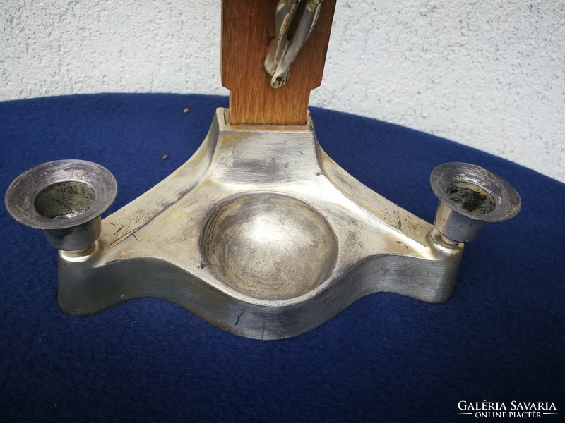 Candlestick with crucifix and holy water holder made of metal. Home altar, blessed Jesus Christ, corpus,