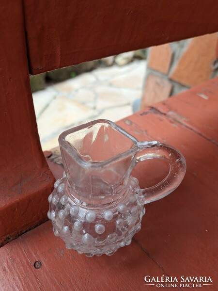 A beautiful narrow 8 cm tall glass jug with a cam and a tiny size for collectors