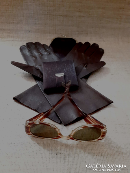 Retro amber colored sunglasses in a leather case with leather half-length gloves and a small mirror.