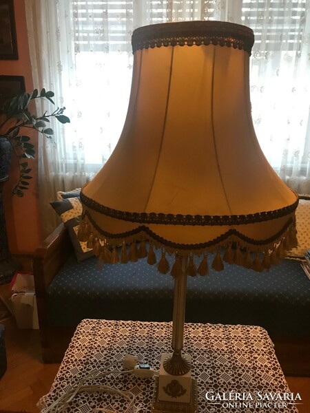 A particularly beautiful table lamp with a silk shade and a copper-granite base. The shade silk is damaged inside.