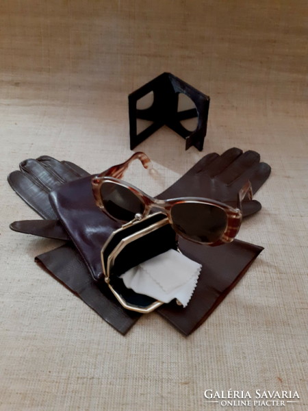 Retro amber colored sunglasses in a leather case with leather half-length gloves and a small mirror.