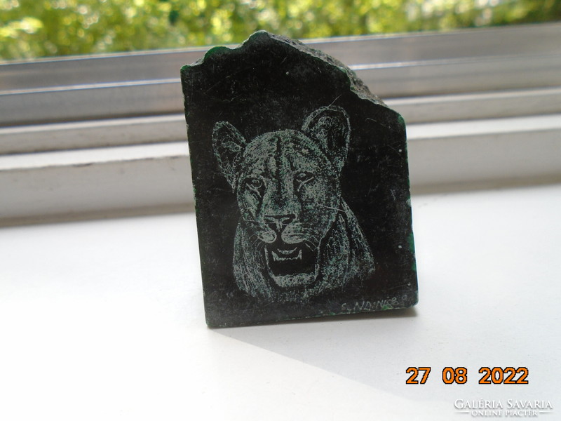 Polished stone with the signature image of a panther