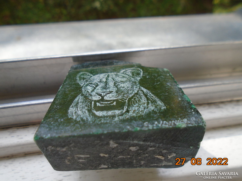 Polished stone with the signature image of a panther