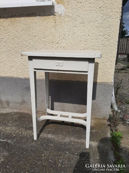 A very charming antique small table with a nice lock cover and stylish legs