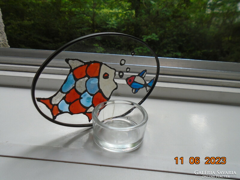 Colored enamel fish painted on leaded glass with a candle holder