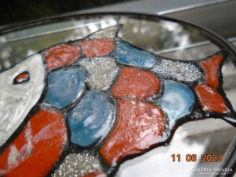 Colored enamel fish painted on leaded glass with a candle holder