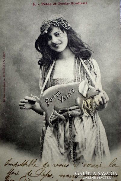 Antique photo postcard of a cheerful lady with a pig