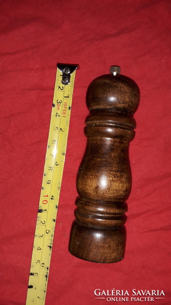 A manual black pepper grinder with a wooden cover in very nice condition, as shown in the pictures