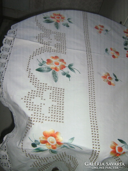 Hand-embroidered white linen tablecloth with a beautiful color scheme and a lace edge